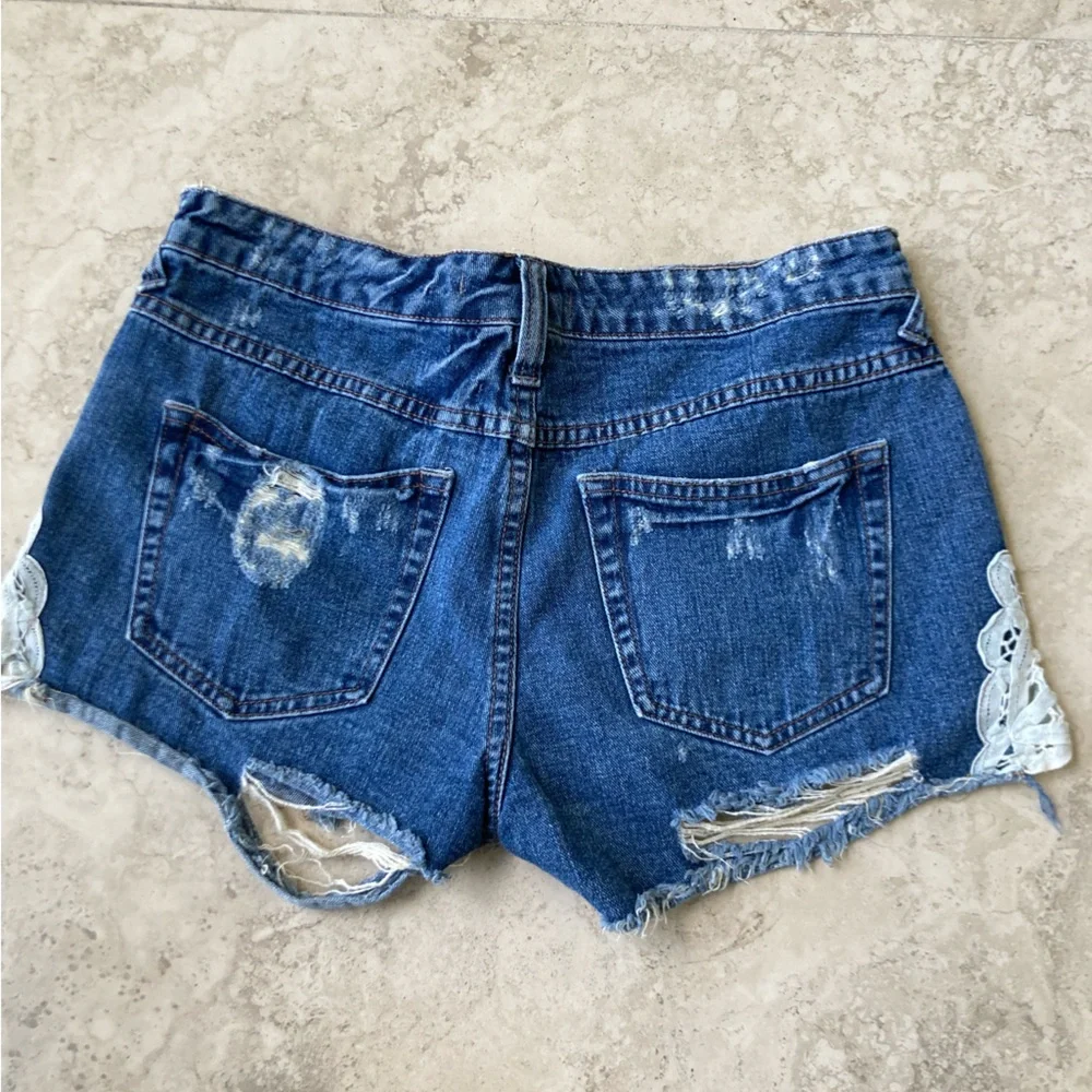 Free People Distressed Blue Denim Shorts with Lace Accents